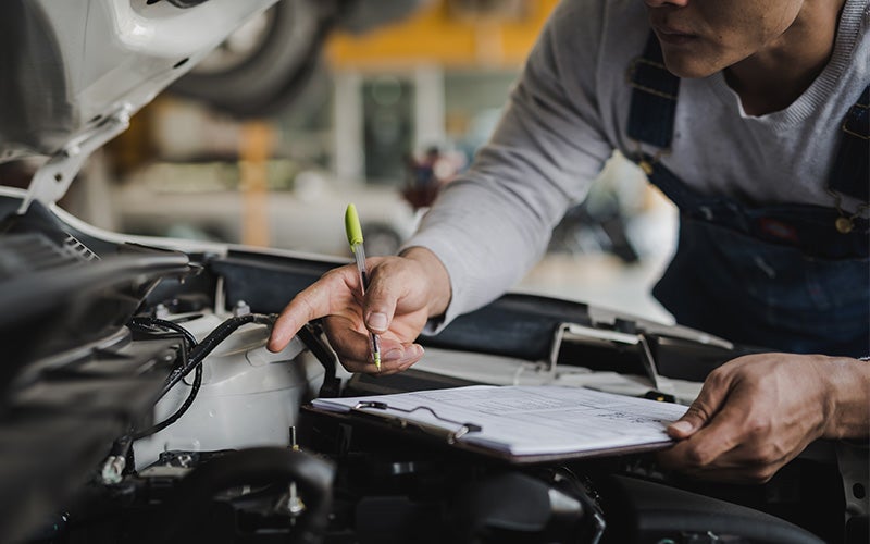 service tech inspecting vehicle Jerry's Auto Group in Lennox SD